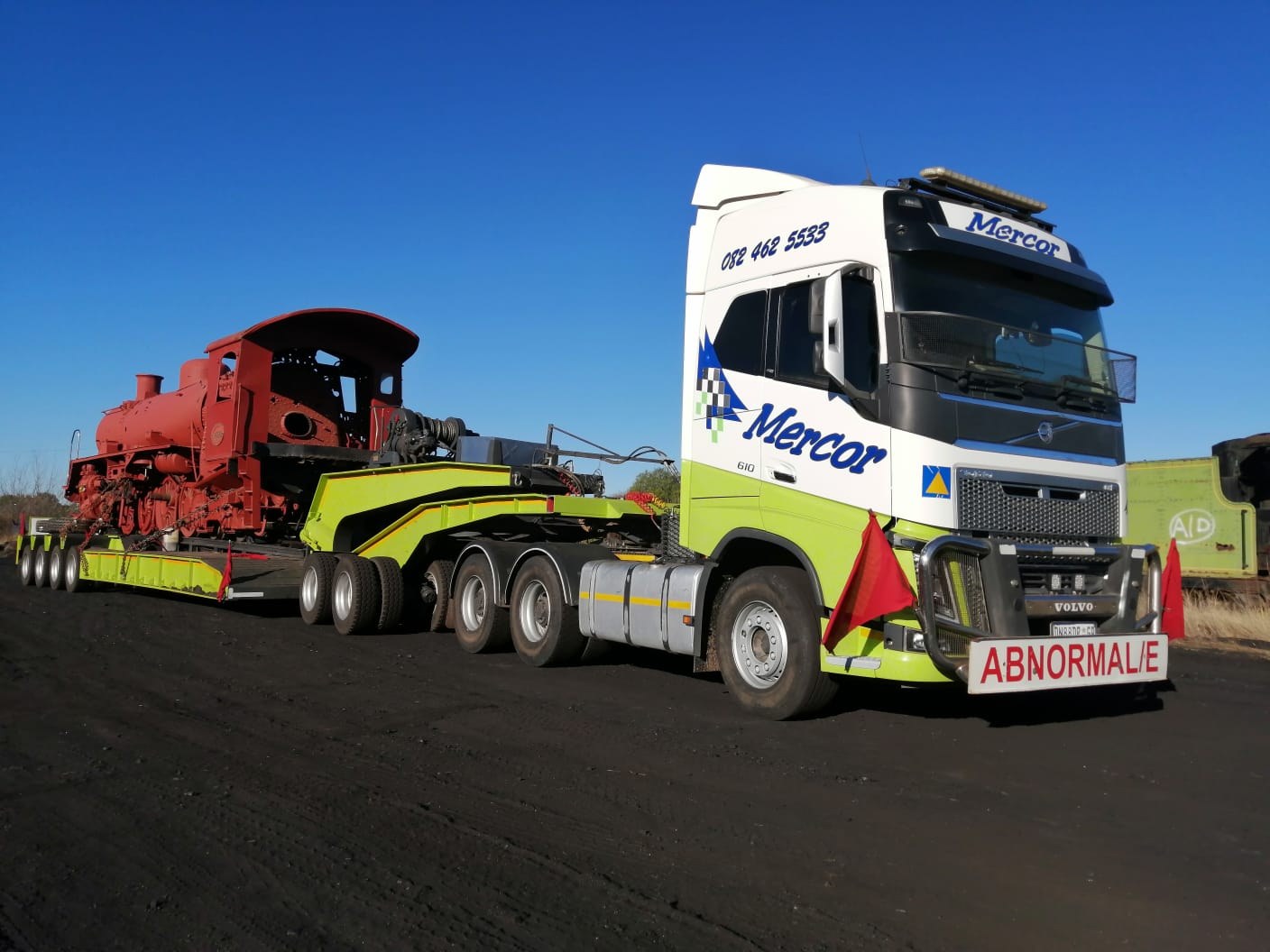 Mercor Transport locomotive on lowbed under blue sky
